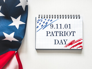 Patriot Day. We will never forget. American flag and lettering. Closeup, isolated background....