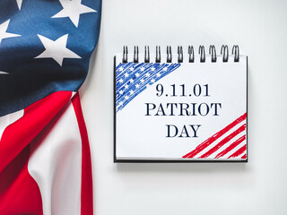 Patriot Day. We will never forget. American flag and lettering. Closeup, isolated background....
