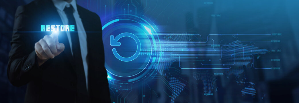 Businessman interacts with a futuristic "RESTORE" interface featuring a circular arrow icon, symbolizing data recovery, system restoration, and the future of digital continuity and backup solutions