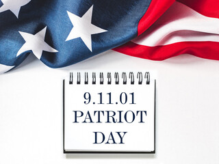 Patriot Day. We will never forget. American flag and lettering. Closeup, isolated background....