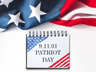 Patriot Day. We will never forget. American flag and lettering. Closeup, isolated background....