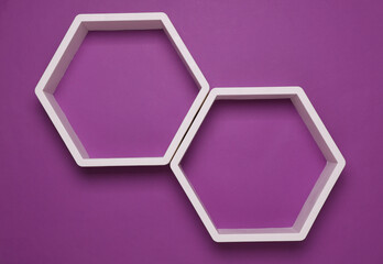Hexagonal honeycomb wall shelves on purple background