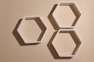 Hexagonal honeycomb wall shelves on beige background