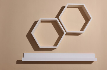 White hexagonal and straight wall shelves on beige background