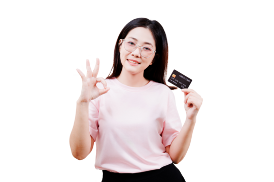 Asian young beautiful woman wearing glasses holds a credit card in one hand while making an OK gesture with the other, smiling confidently. - Powered by Adobe