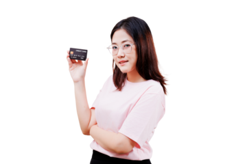A confident Asian young beautiful woman wearing glasses holds a credit card, dressed in a light pink shirt with her arms crossed.