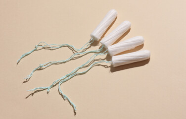 Tampons for feminine intimate hygiene on a beige background. Menstruation, critical days, female cycle