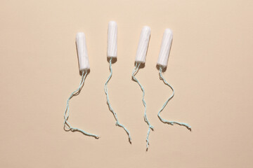 Tampons for feminine intimate hygiene on a beige background. Menstruation, critical days, female...