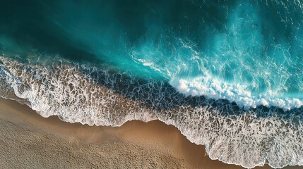 Turquoise waves meet sandy shore, an aerial view of nature's serene beauty and harmony.
