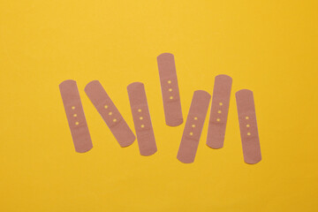 Medical Adhesive bandage plasters on yellow background