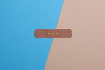Medical Adhesive bandage plaster on blue beige background