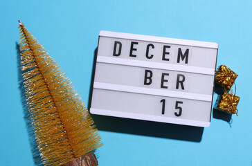 Lightbox calendar with text December 15 with Christmas, New Year winter decor on blue background