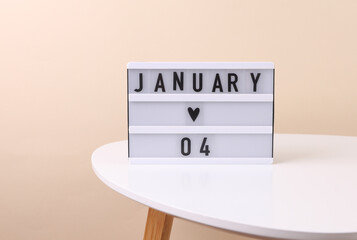 Lightbox calendar with date january 04 on table