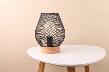 Loft lamp on the table, beige background