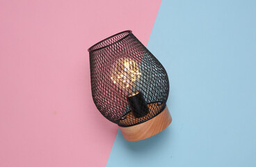 Loft lamp on pink blue background. Top view