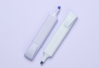 Markers or colored felt-tip pens on purple pastel background. Creative layout