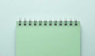 Spiral notepad on blue pastel background