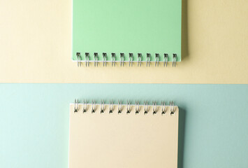 Two notebooks on blue yellow pastel background. Minimalism. Creative layout