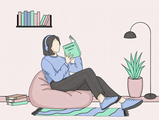 Cozy woman reading psychology book on bean bag in modern interior