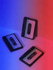 Retro 80s audio cassettes in neon light. Creative layout, minimalism, music lover