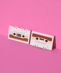 Retro 80s audio cassettes on pink background with shadow. Creative layout, minimalism, music lover