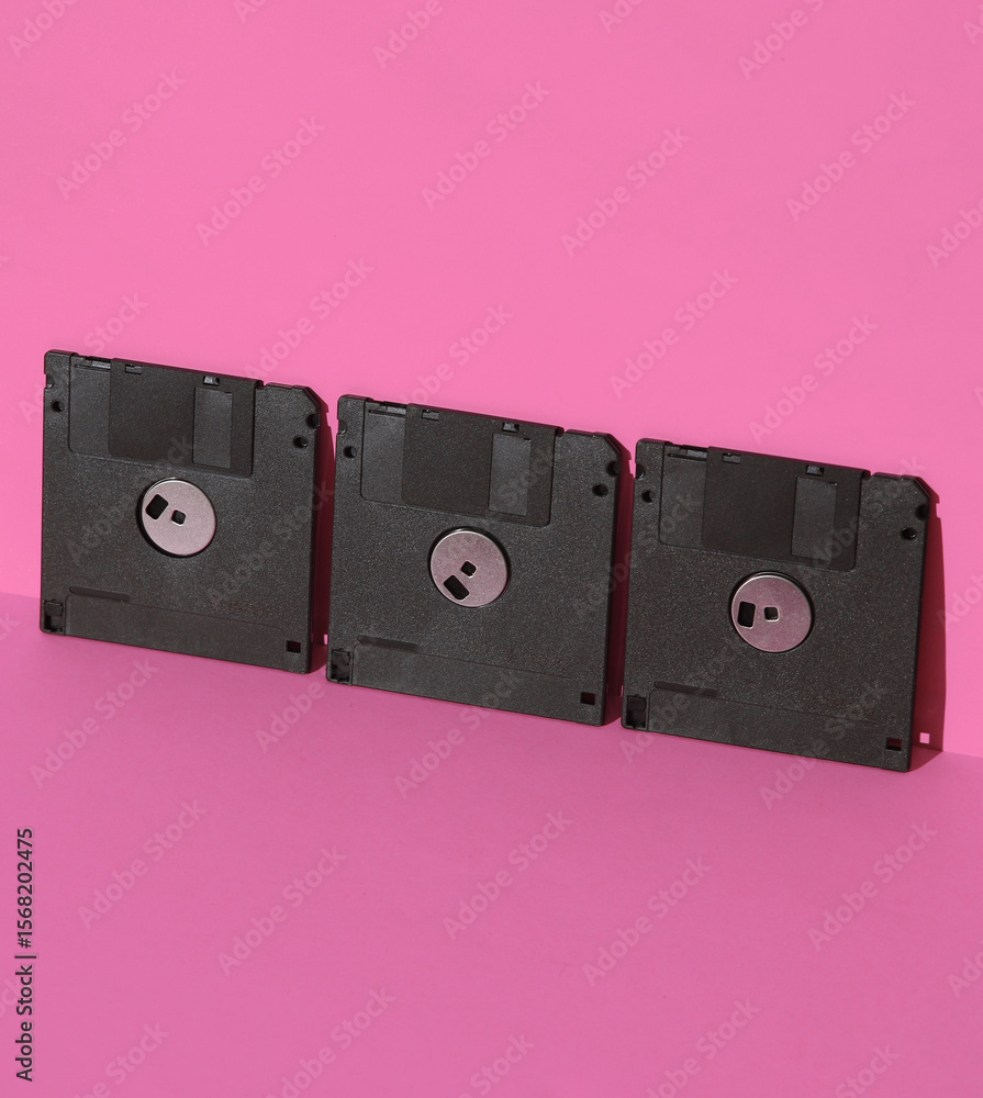 Poster outdated technologies. retro 80s floppy disks on pink background with shadow. creative layout