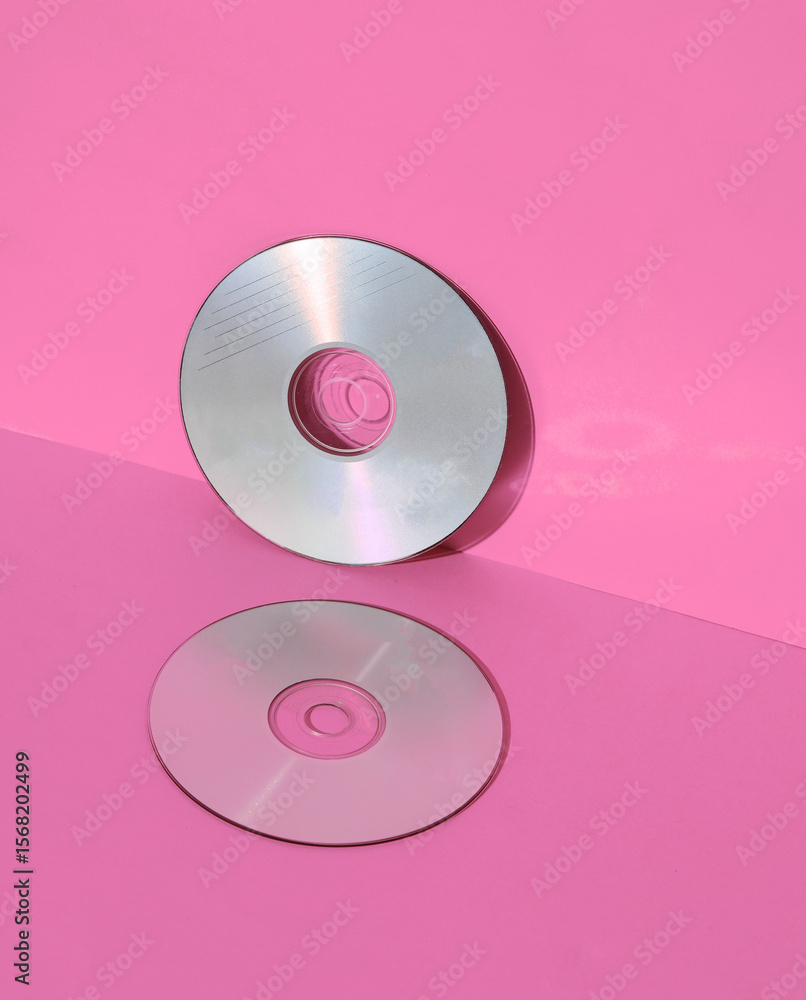 Poster outdated technologies. cd disks on pink background with shadow. creative layout