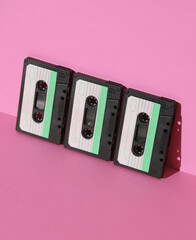 Retro 80s audio cassettes on pink background with shadow. Creative layout, minimalism, music lover