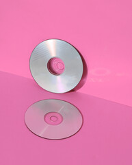 Outdated technologies. Cd disks on pink background with shadow. Creative layout