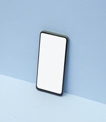 Smartphone on blue background. Creative layout.