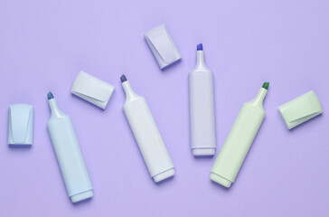 Markers or colored felt-tip pens on a pastel background. Top view. Creative layout