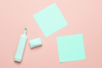 Blue Markers and memo paper sheets on pink background
