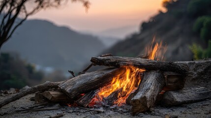 Campfire at sunset, mountains in the background
