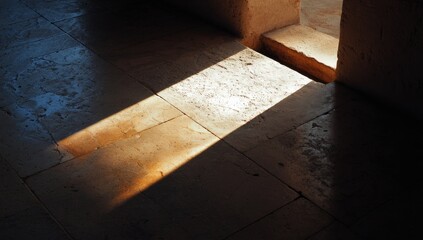 Sunlight streams onto stone floor, creating dramatic shadows