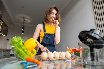 Healthy young woman try sliced vegetable for green diet, detox and breakfast in kitchen....