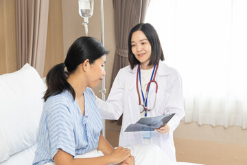 Hospital, healthcare, medical, doctor, nurse consults smiling patient at bedside, offering trust,...