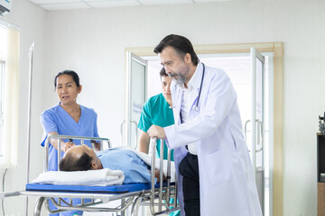 Hospital, healthcare, medical, doctor, nurse rush patient through corridor on emergency gurney,...