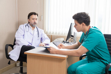 Hospital, healthcare, medical, doctor, nurse, Senior specialist sits with young assistant...