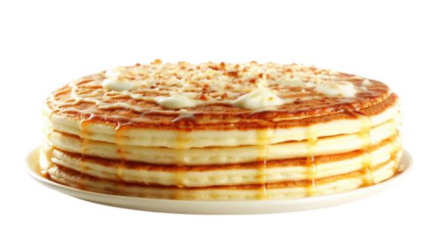 A delicious stack of pancakes drizzled with syrup and cream, ready to enjoy.