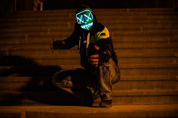 Purge mask, halloween with pumpkin. LED mask, creepy scary man. Corona, Funny, October, outside