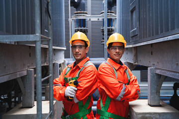 Two men in orange safety gear stand next to each other