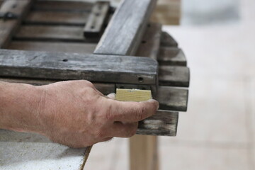 Carpenter making a table from recycled wood with a hinge