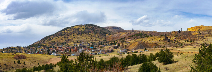 A wide view of Cripple Creek, Colorado, nestled against rolling hills and old mining structures....