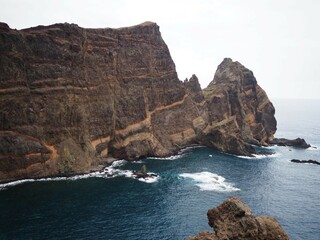 Fototapeta premium Desert landscapes of Cape Sao Lourenco. Volcanic cliffs rising above the ocean. Nature of Madeira Island, Portugal, PR8 Vereda da Ponta de Sao Lourenco.