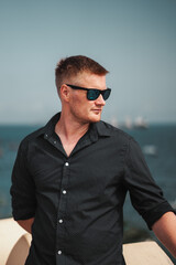 Summer fashion smart casual male model wearing sunglasses