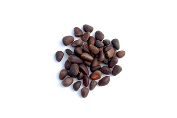 There is a pile of unpeeled pine nuts on a white background.