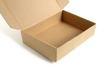 A brown cardboard empty box stands on a white background.