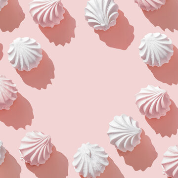 Frame from Pink and White zephyr, marshmallow on Pastel Pink Background, Top view close up of swirled meringue cookies with sun shadows, minimal flat lay pfoto of  sweet dessert, sweetness, copyspace