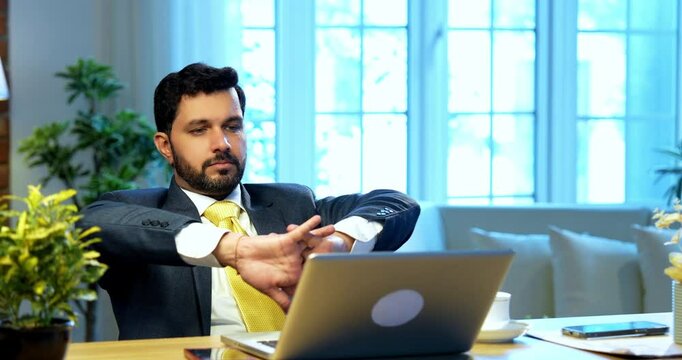 Businessman drafting email or typing on laptop sitting at office desk, Indian Asian corporate executive focused on communication, digital work, online correspondence, modern business productivity