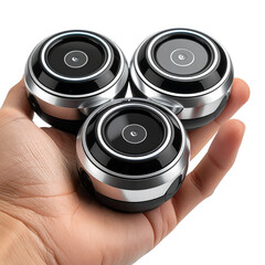 Three small round technology devices in hand against dark background
